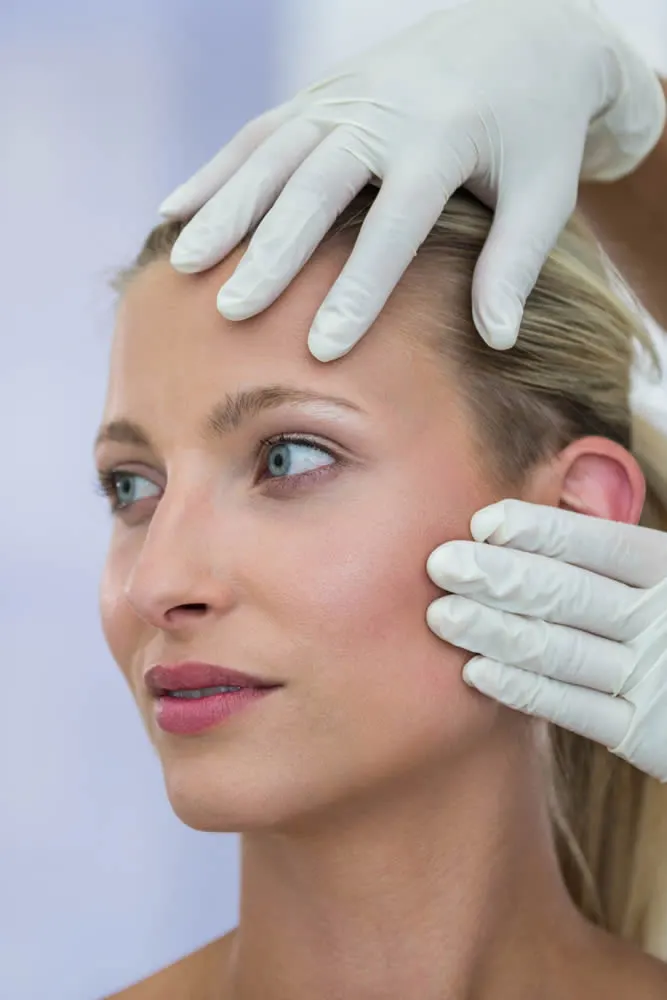 happy mature woman dermatologist-checking-patient-before-instalift