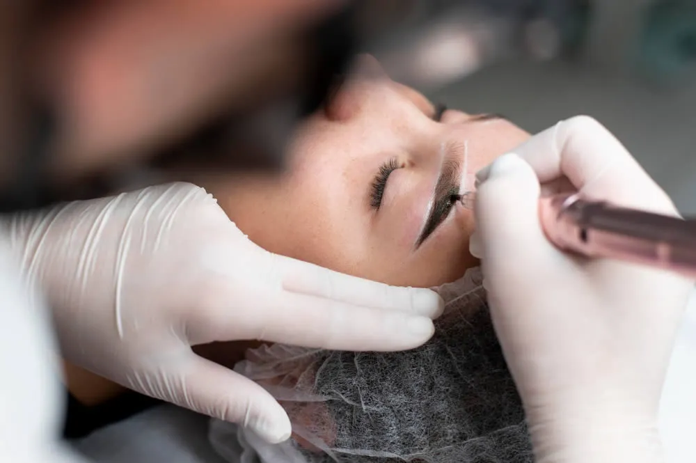 age-spots young-woman-going-through-permanent-makeup-eyebrow-treatment
